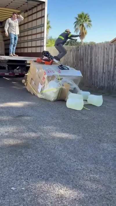These two gentlemen lose control of a pallet as it falls of the back of a truck