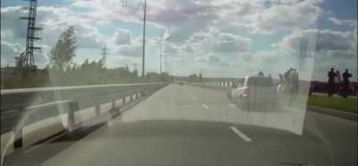 A stalled car and it’s driver get destroyed