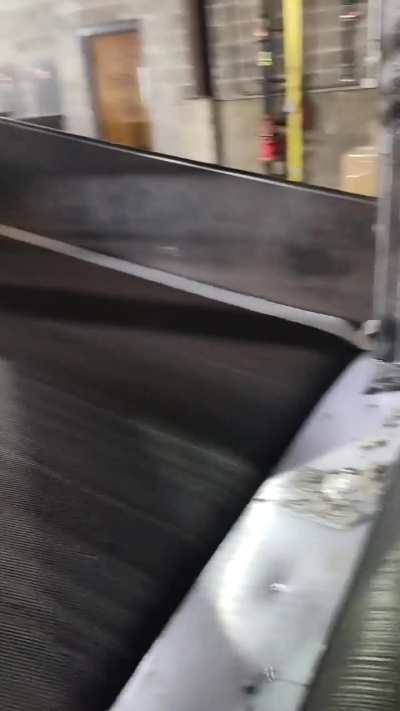 Paper sticker roll goin up a belt