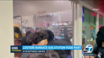 Hundreds of people looting a gas station food mart in Los Angeles early yesterday morning