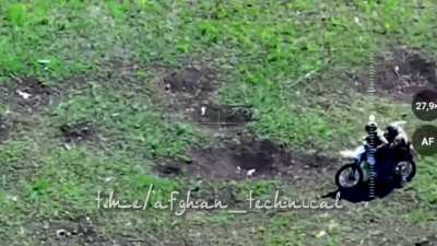 RU POV: Two soldiers are having a hard time riding a motorcycle while dodging artillery and suicide drones.Ro