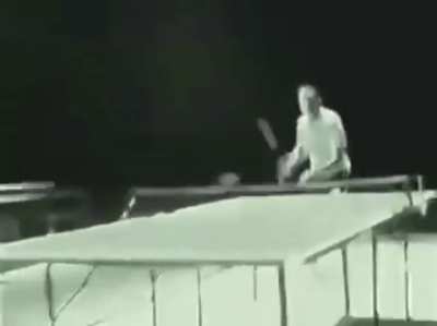 Bruce Lee playing ping-pong with nunchucks.