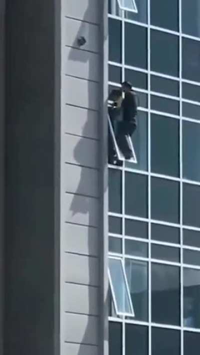 The man climbed out of his eighth floor apartment window to catch the helpless three-year-old girl.