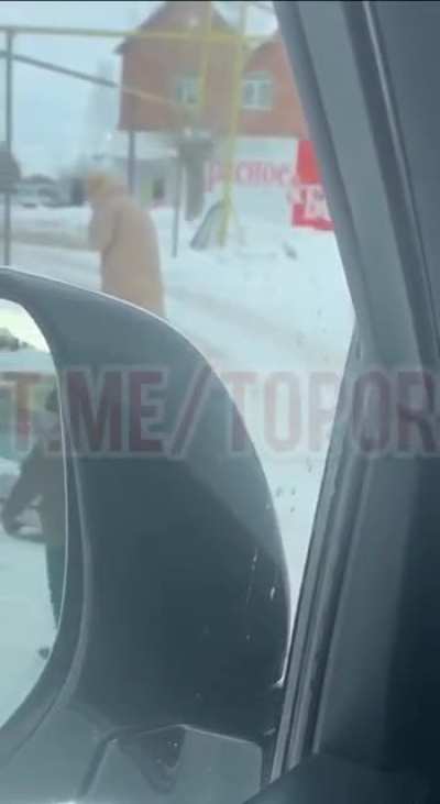 A woman in Kataisk, Russia, catches a pigeon and eats it raw, spitting its feathers into the spring snow