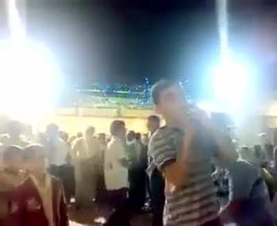 Man hands over a loaded gun to his child at a party.