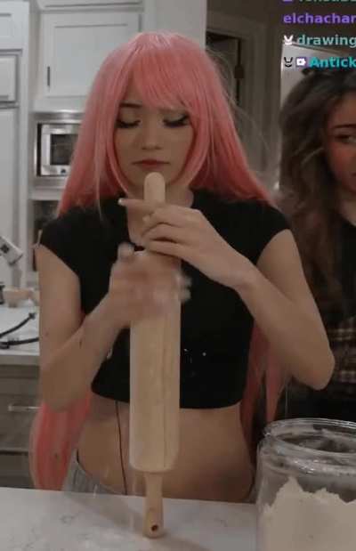 Emiru getting lost in thought stroking the rolling pin. The size reminds her of the six old men she milked at the retirement home she volunteered at yesterday