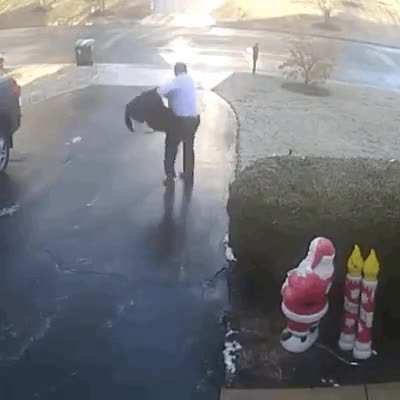 Black ice sends man sliding down his driveway.