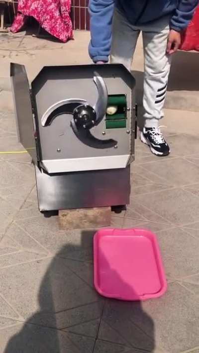 Using a machine to cut a vegetable
