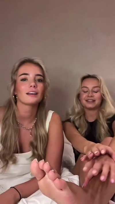 2 beautiful women playing with eachothers feet