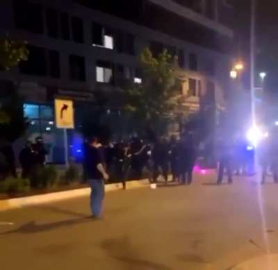 Protester gets a flash-bang to his face after getting pepper sprayed.