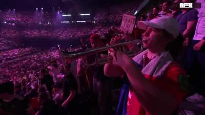 Crowd hyped, there's a trumpet.