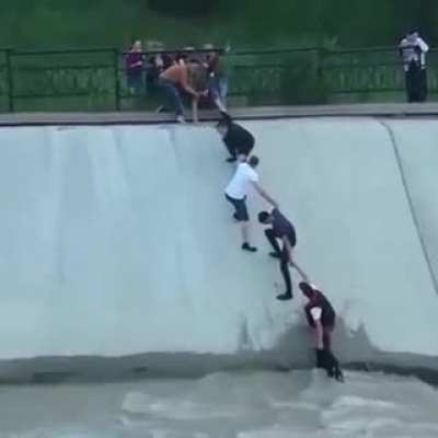 people form a human chain to rescue this dog from a dam, awesome