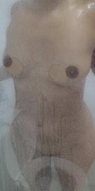 Pressing my big nipples against the glass in the shower for you