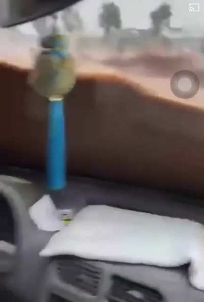 Man stuck inside of car during flood. (China)
