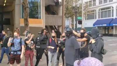 Guy steals a cross from pro-trump protesters gathered at the site where Aaron Danielson was killed in Portland and asks to get beaten up