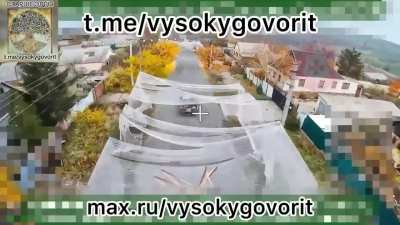 Ukrainian ute driving through an old netted corridor gets struck by FPV drone