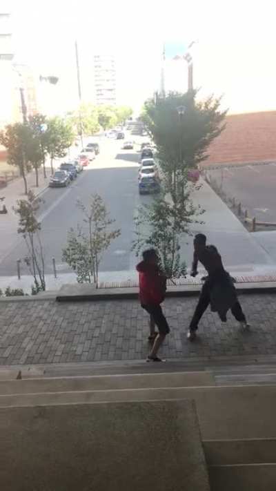 Beef at Central Library this afternoon. The guy in the red had a knife and was about to stab the guy with no shirt. After I pulled out my camera the guy in the red noticed and let go of being dominant. You can see him hiding his knife in his hoodie pocket