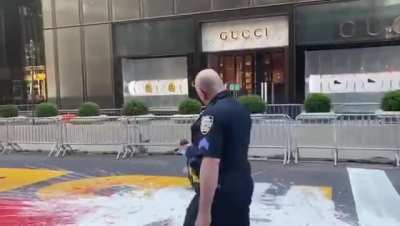 Grown man on the ground covered in paint trying to deface a BLM mural