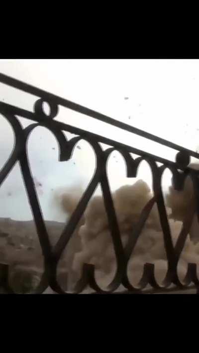 Cameraman capture a crazy shot of a helicopter dropping an unguided bomb right next to his house