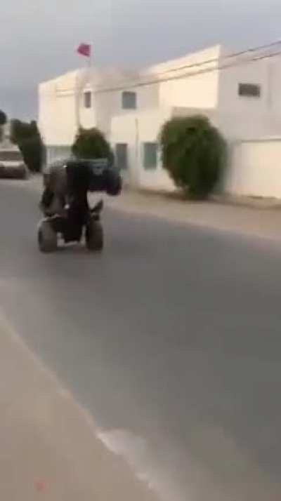 To do a wheelie in a quad bike