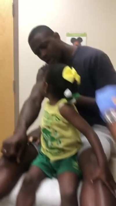 Dad gets (pretend) vaccinated first so the daughter is less scared