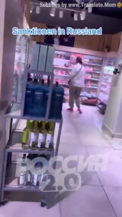 ru pov: A German walked around a Moscow supermarket showing goods on the shelves.