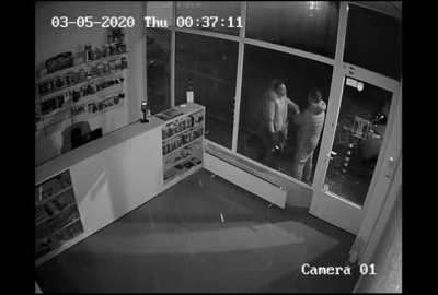 Angry woman headbutts a shop window and the guy casually walks away