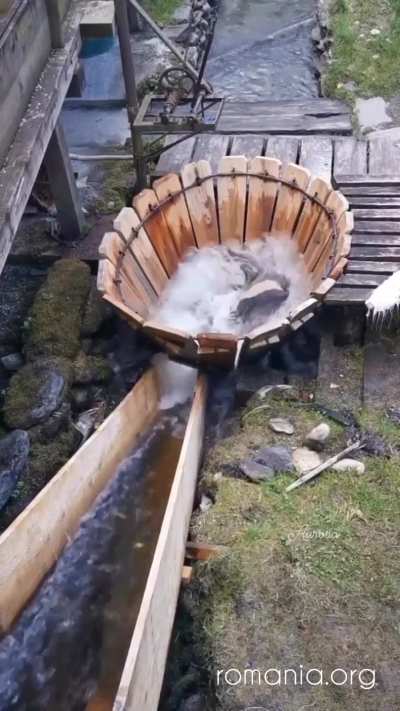Traditional mechanism (vâltori) for washing clothes under running water from a river in Romania