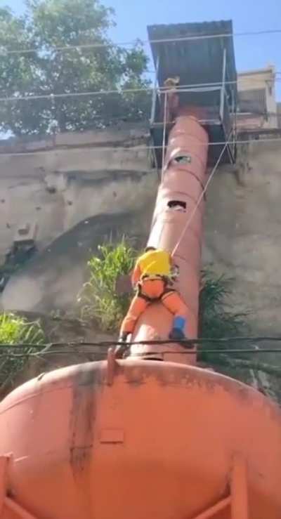 Worker clearing a hopper is electrocuted when his tool touches a power line