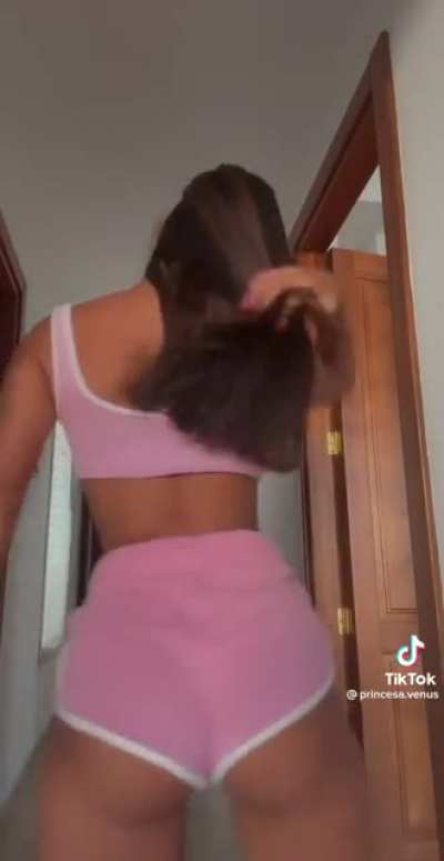 Pulling her shorts up