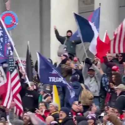 NEW FOOTAGE: a long, disciplined line of men in body armor moves as a unit up the Capitol Building steps