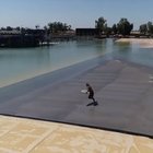 Surfer rides a wave created by a train