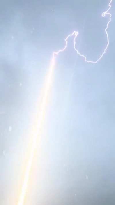 Lightning Bolt Is Guided To Ground Through Rocket Trail