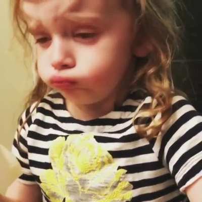 This little girl pretends to like her mom's spaghetti