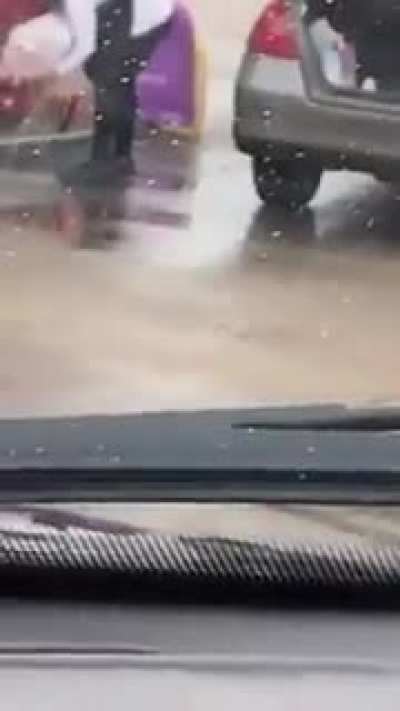 Woman pours gasoline into a plastic bag