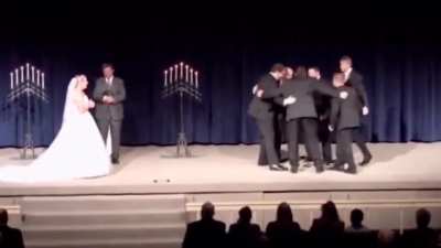 Groom pulling prank on bride during their wedding
