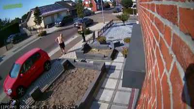 Driving a scooter near a picket fence