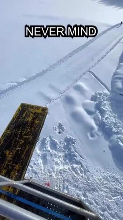 guys jumping into snow from a crane