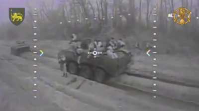 Ukrainian FPV drone hits Russian BTR with several Russians ontop.
