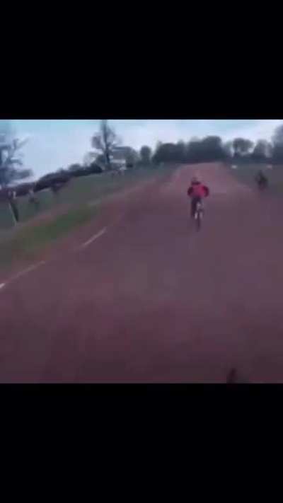 Kid falls over during bicycle race