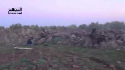 Opposition fighters holding a blocking position maintain a sustained volume of fire during clashes with SAA forces - Quneitra Governorate - 2014
