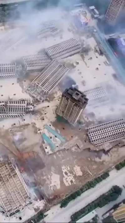 Buildings, falling to their death.