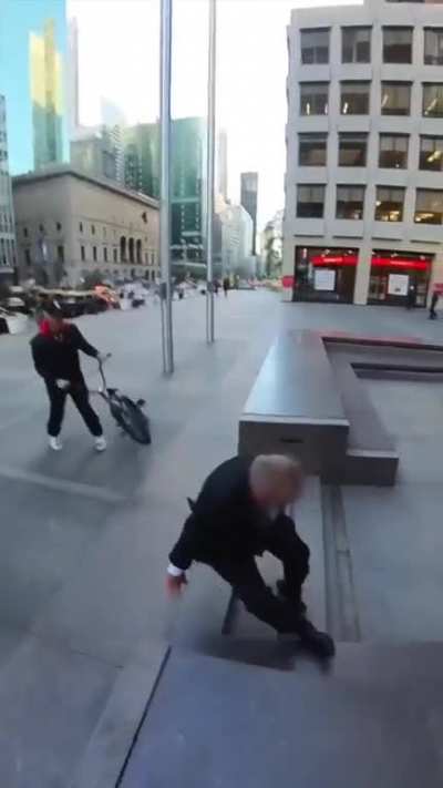 Angry Guy Tries To Grab Kid Off BMX Bike But Falls Instead