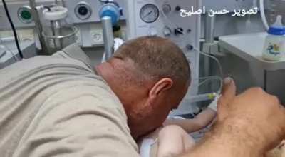 This father sees his only child who survived the Israeli airstrike on gaza refugee camp, his wife and his 4 other kids have died