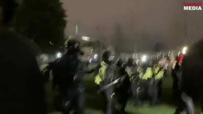 Huge amount of Police deployed to retake the Capitol grounds after launching a massive amount of tear gas to disperse the rioters. The crowds have subsequently thinned out.