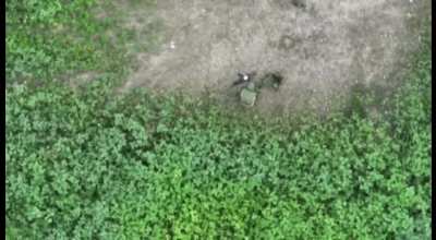 A Ukrainian drone dropping a munition on a Russian soldier trying to take a dump