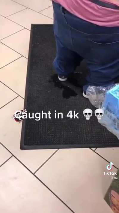 guy pisses himself as he checks out from a store