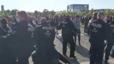 Anti-Lockdown Protester kicks sound assistant