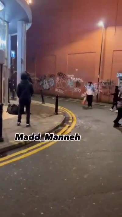 Man brandishing a knife is confronted by bystanders and police in Manchester, UK