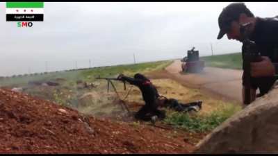 Opposition fighter lets off a sustained PKM burst towards SAA positions near Izraa, Syria - 2014